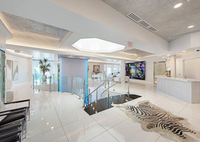 A white tiled lobby with a zebra rug.