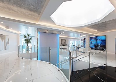 The lobby of a modern office with a circular staircase.