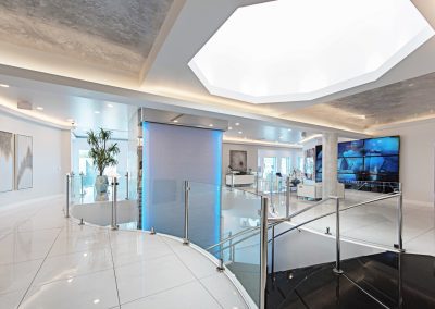 The lobby of a modern office with a glass ceiling.