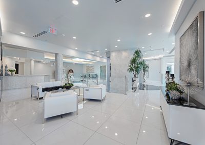 The lobby of a modern office with white furniture.