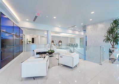 The lobby of a modern office with white furniture.