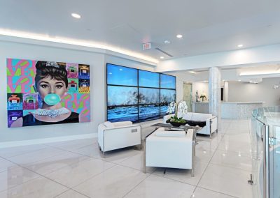 A lobby with a large painting on the wall.