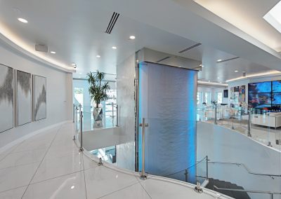 The lobby of a modern home with a glass wall.