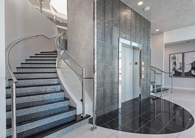 An elevator and stairs in a modern building.