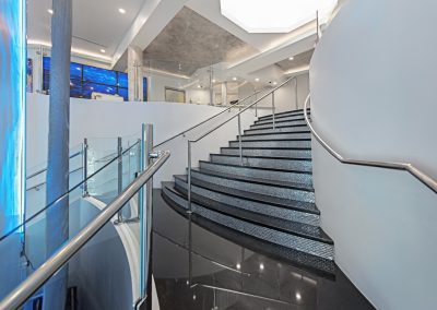 A glass staircase in a modern office building.