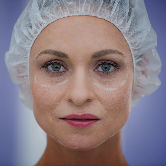 A woman in a white hat with makeup on her face. A woman in a white hat with makeup on her face.