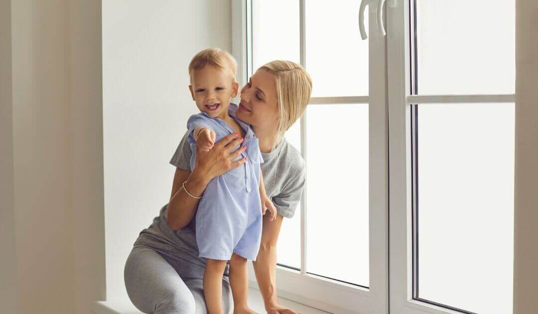 Happy mother holding her child after a successful mommy makeover package in Las Vegas.