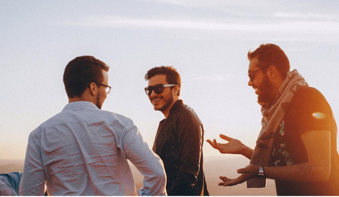 Three confident men smiling outdoors after male plastic surgery procedures in Las Vegas