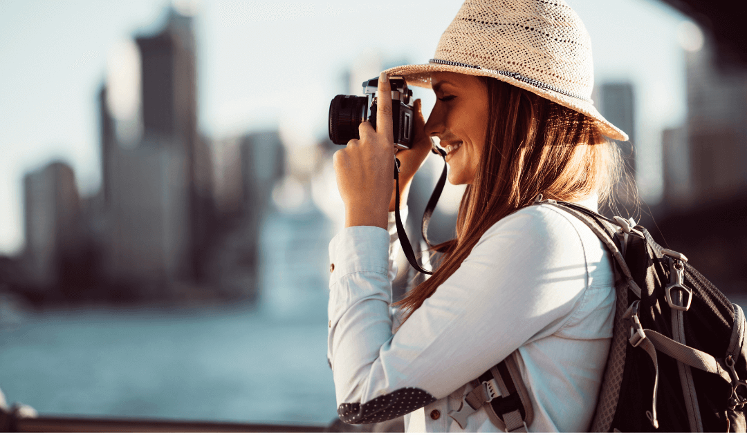 A woman taking photos while exploring Las Vegas as a medical tourist recovering from plastic surgery with the highest level of privacy.